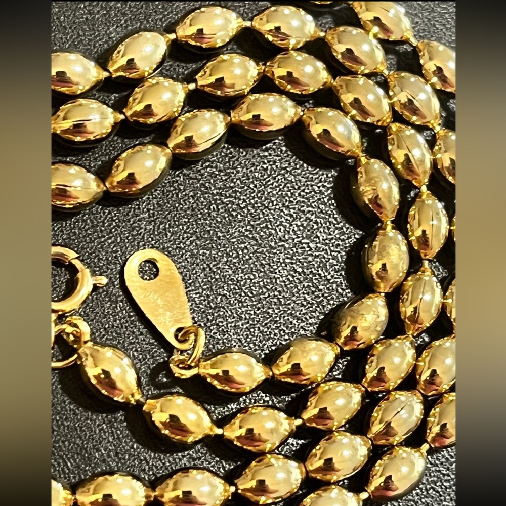 Beaded gold tone necklace approximately 24inches long.